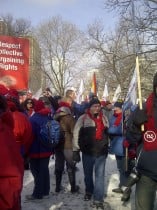 Members stand outside at a rally in Sault Ste. Marie and District
