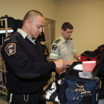 Two paramedics packing their equipment bags