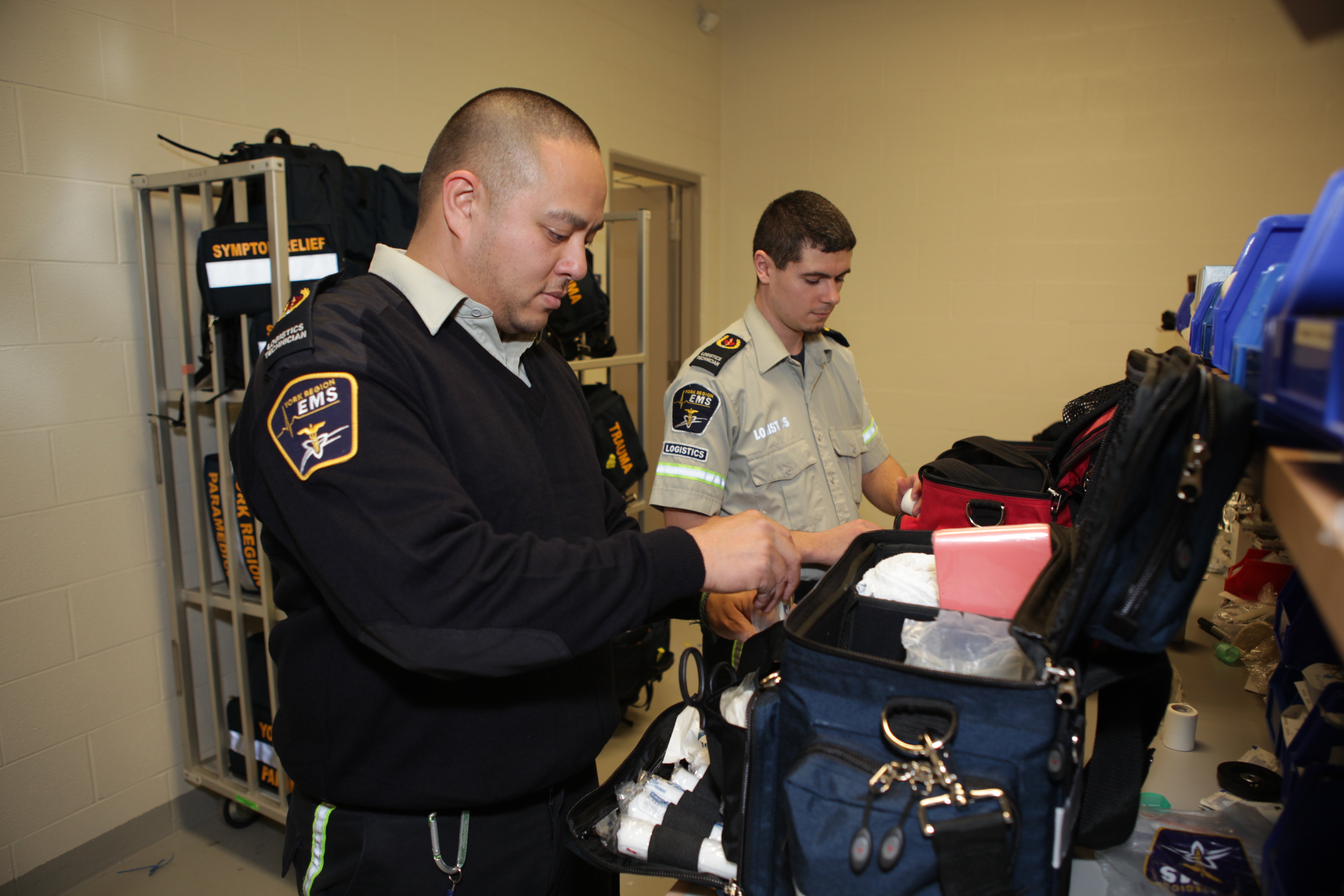 Two paramedics packing their equipment bags