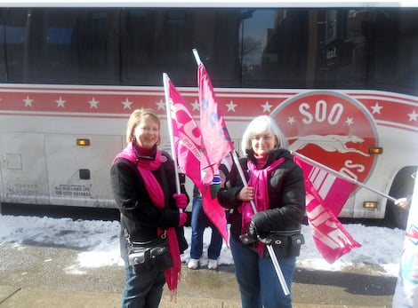 Two members with flags at Sault Ste. Marie and District
