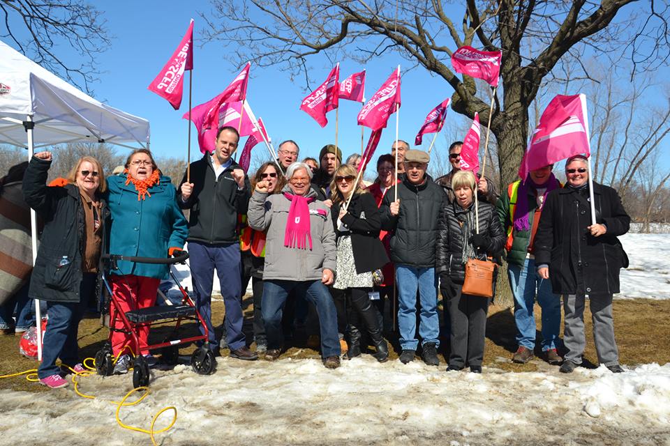 A dozen members smile for the camera at a CUPE 3903 Rally