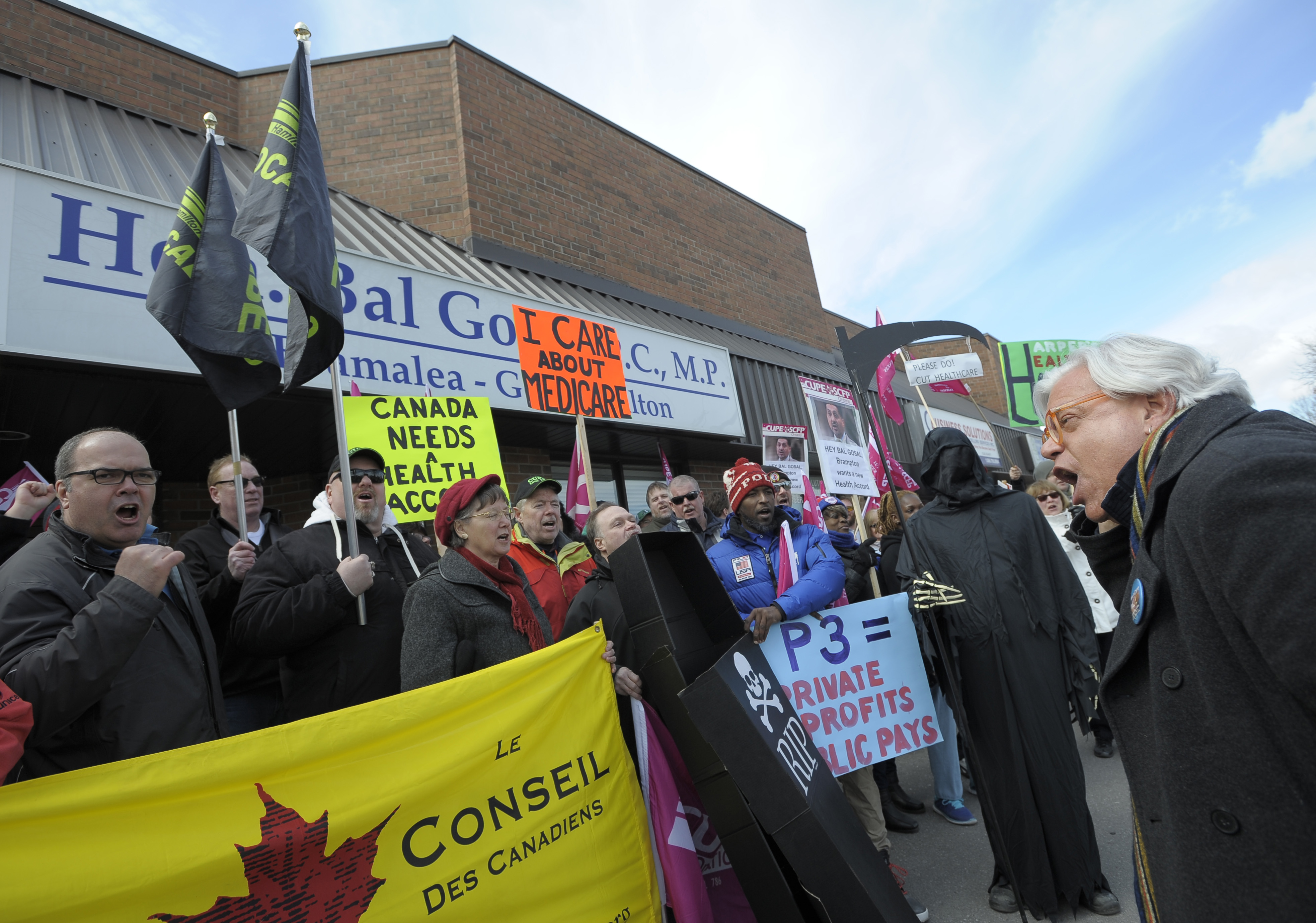 Fred Hahn and members with signs and banners at CUPE rally at Bal Gosal's Constituency office