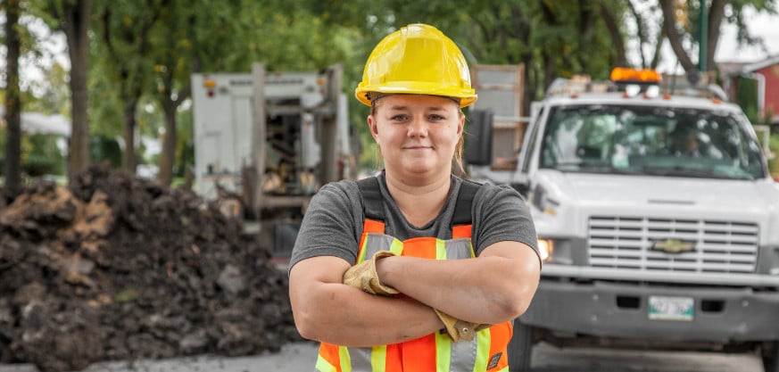 Outdoor worker smiling with arms crossed