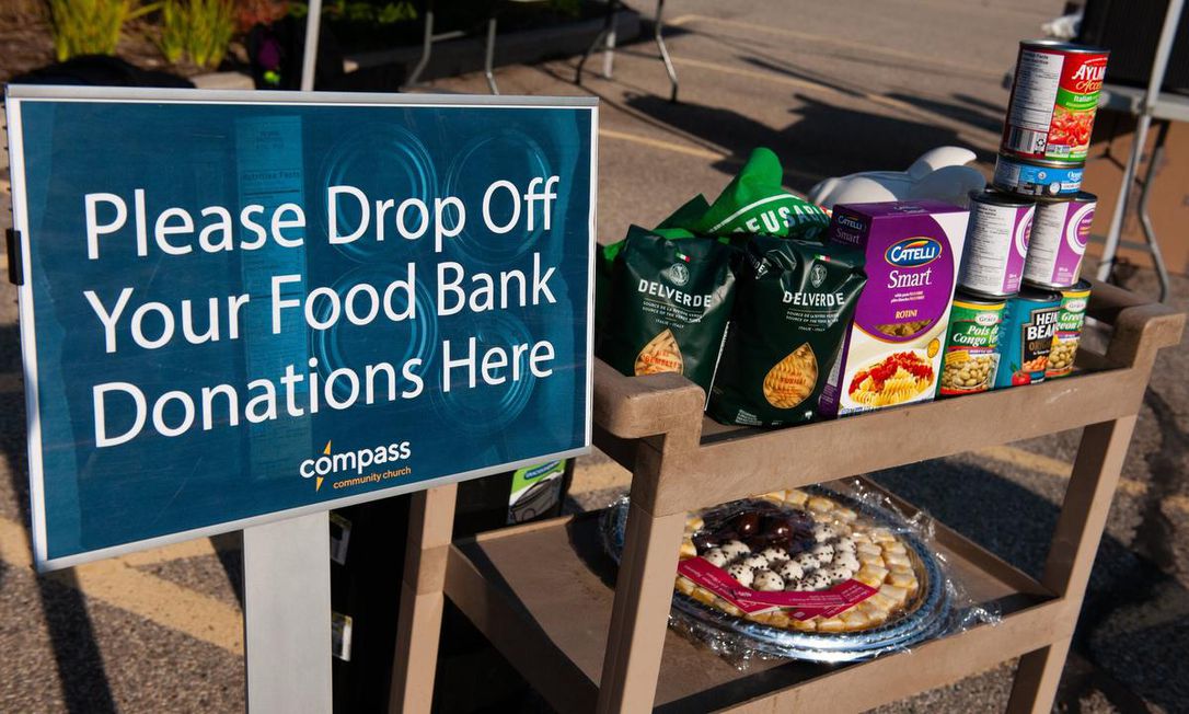 Image shows packaged food on a cart beside a sign that reads 
