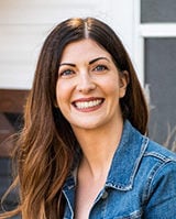 Image shows Tiffany Balducci outdoors, looking at the camera and smiling.