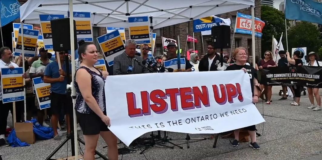 Image shows union members participating in the Listen Up protest outside of Queen's Park in Toronto on Monday, August 8, 2022.